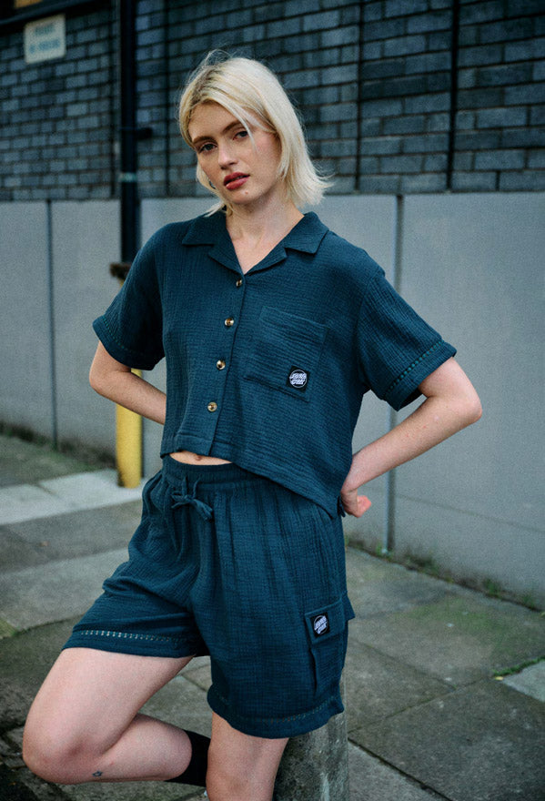 Woman wearing the Santa Cruz Dune crop Shirt and cargo shorts in deep sea.