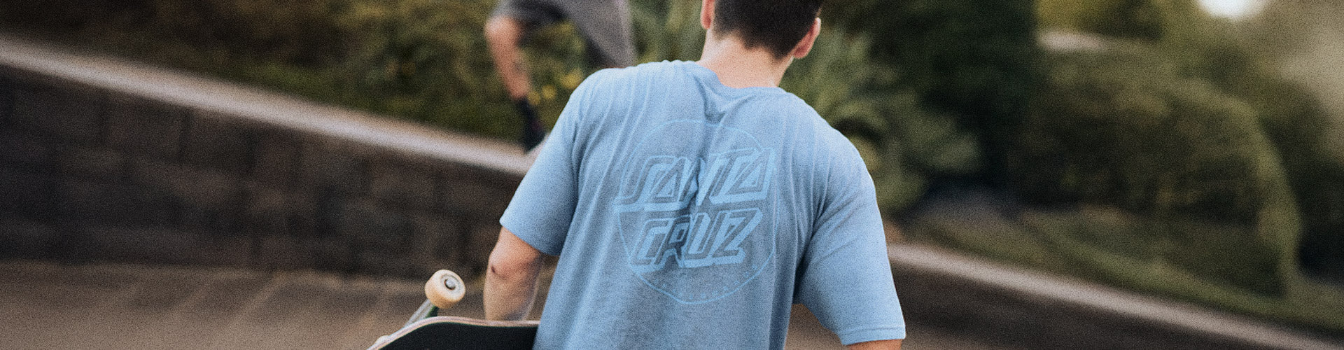 Santa Cruz Classic Dot Collection. Person wearing a blue Santa Cruz t-shirt with the Classic Dot logo on the back.
