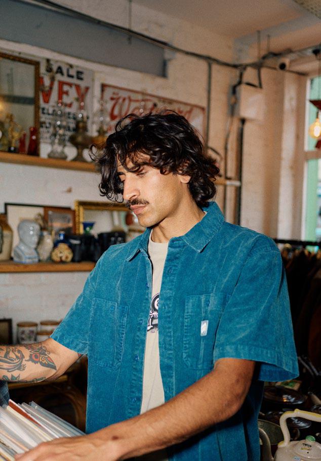 Man wearing a blue Santa Cruz Jimi shirt in a room with vintage decor